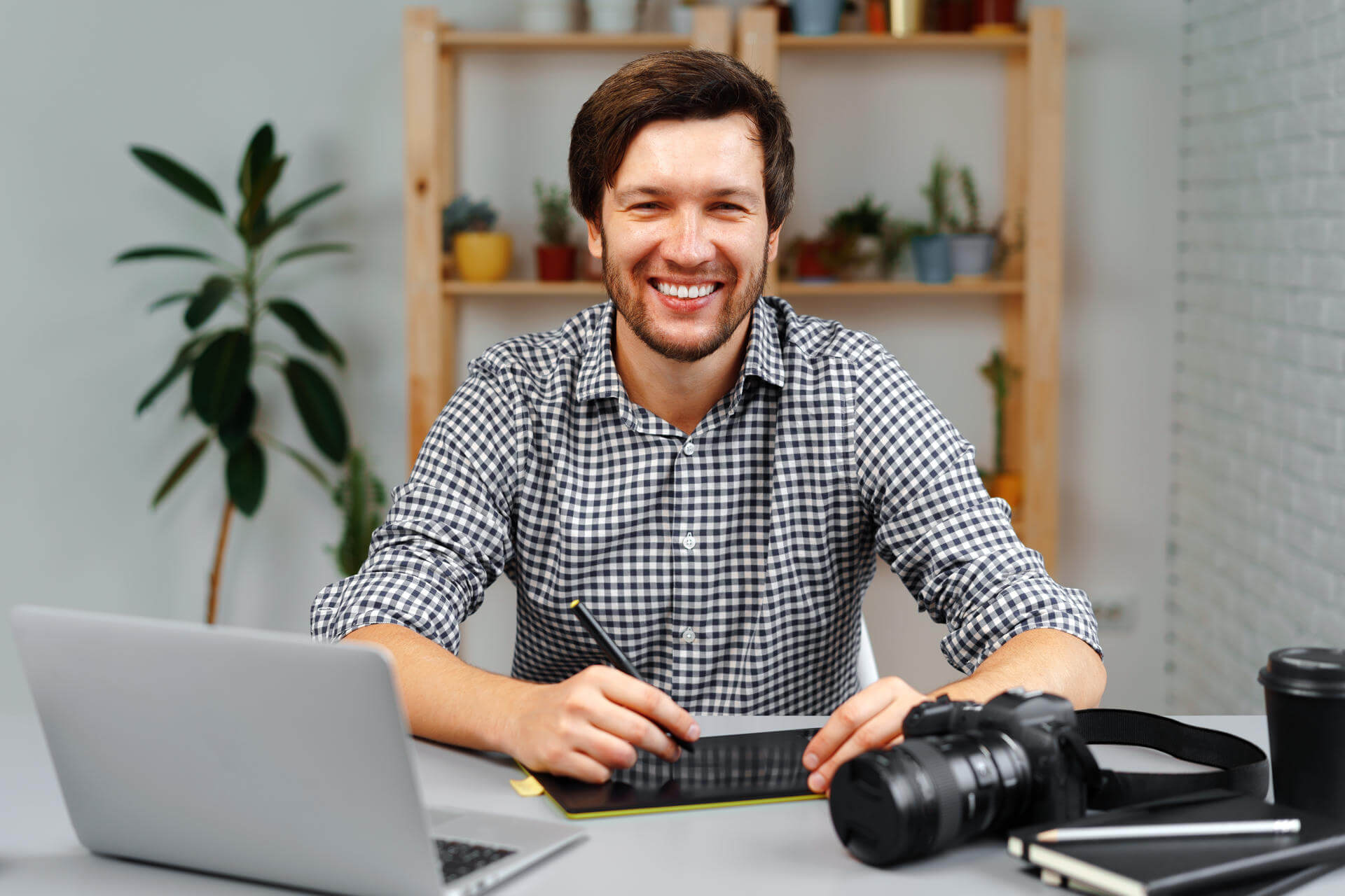 young-man-photographer-sits-at-table-and-works-fro-2025-02-24-20-05-58-utc.jpg